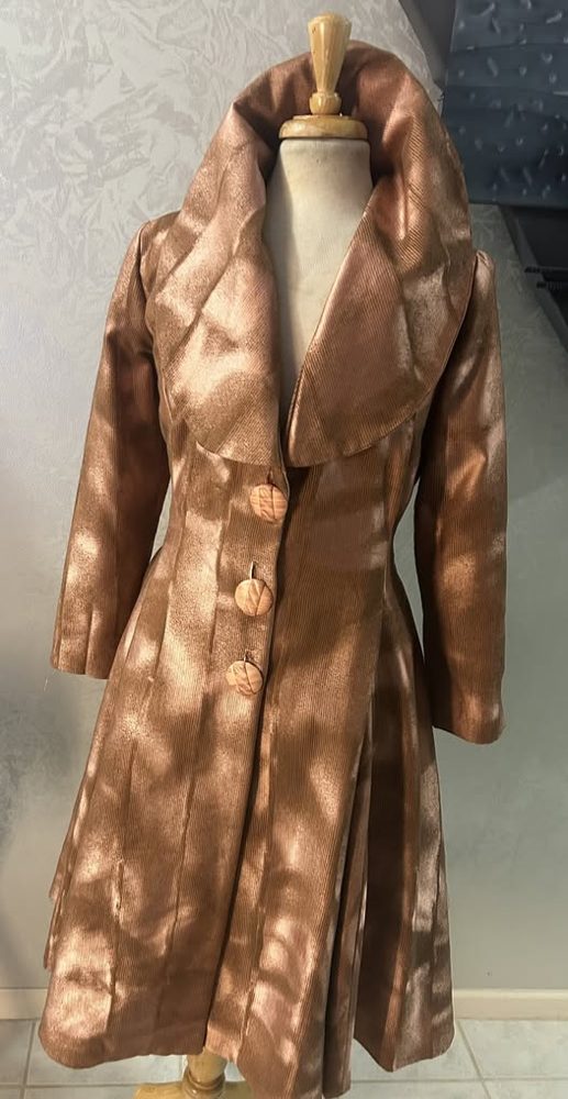 Long bronze coat on a dress form