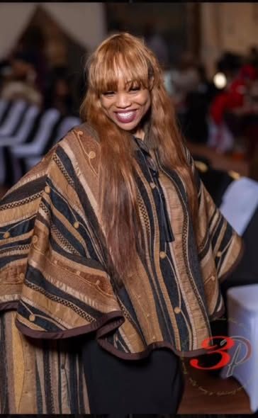 Brown striped poncho on the runway